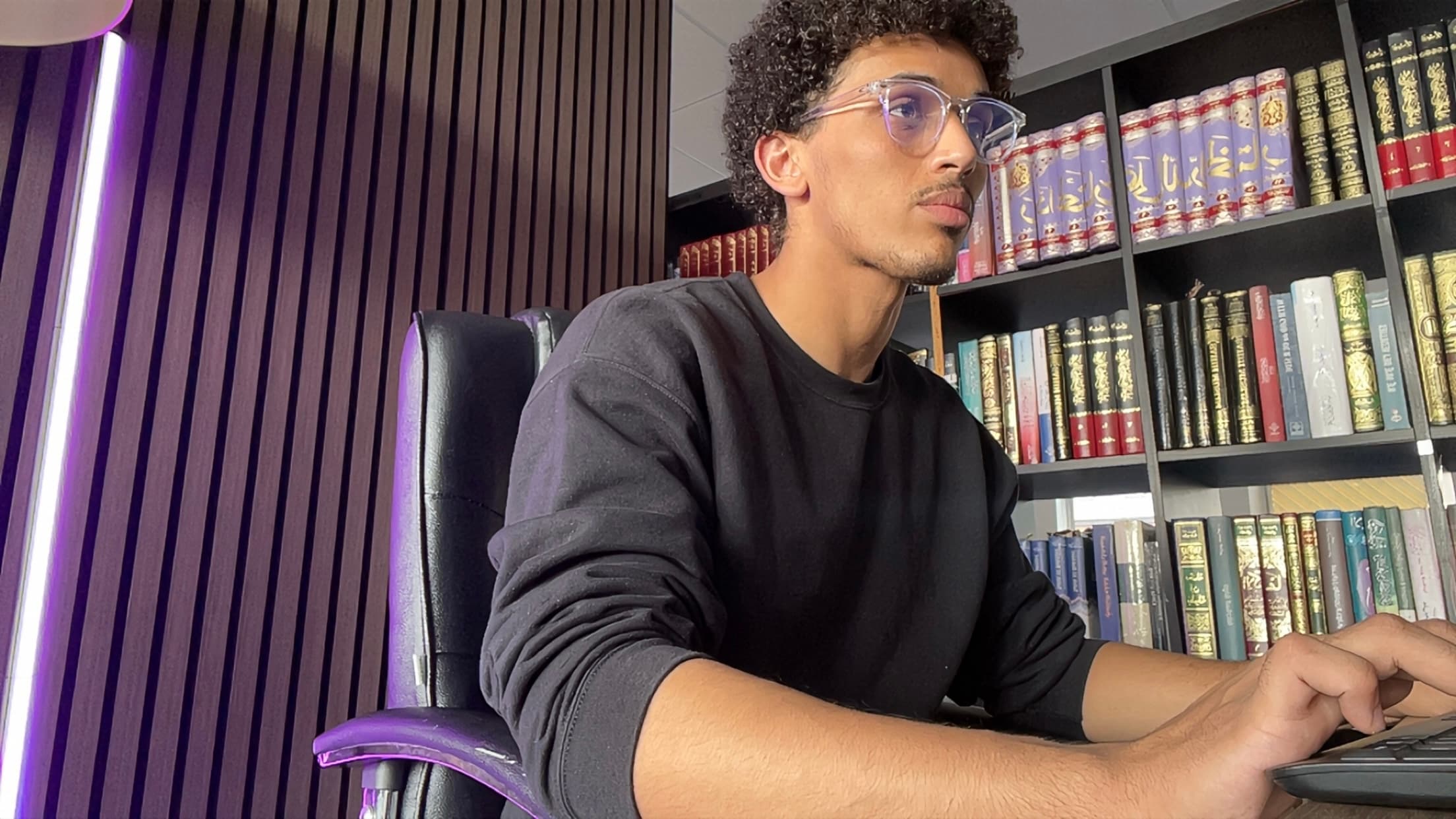 Okasha Abdirahim working at his laptop
